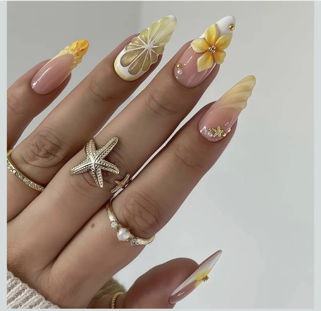 Nudefarbene Nägel mit Zitronenscheiben und gelben Blüten